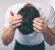 mens hair loss solutions in garden city, man touching the top of his hair